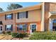 Two story townhouse with brick and beige vinyl siding and dark shutters on a sunny day at 386 Northdale Ct, Lawrenceville, GA 30046