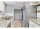 Bright kitchen with stainless steel refrigerator, granite countertops, and eat-in area at 386 Northdale Ct, Lawrenceville, GA 30046