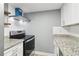 Contemporary kitchen featuring white cabinets, stainless steel appliances, and modern hood at 386 Northdale Ct, Lawrenceville, GA 30046