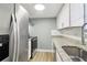 Modern kitchen with stainless steel appliances, granite countertops, and ample cabinet space at 386 Northdale Ct, Lawrenceville, GA 30046