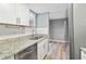 Updated kitchen showcasing granite counters, stainless steel dishwasher, and stylish fixtures at 386 Northdale Ct, Lawrenceville, GA 30046