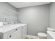 This laundry room has a toilet, a sink, a mirror, shelves, and a washing and drying machine at 386 Northdale Ct, Lawrenceville, GA 30046