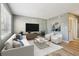 Bright living room featuring modern decor, a plush sofa, and a large flat-screen TV at 386 Northdale Ct, Lawrenceville, GA 30046