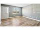 A bright living room featuring wood floors, a large window, and a front door at 386 Northdale Ct, Lawrenceville, GA 30046