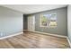 A bright living room featuring wood floors, a large window, and a front door at 386 Northdale Ct, Lawrenceville, GA 30046