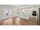 Modern kitchen with white cabinetry, large island, stainless appliances, and hardwood floors at 420 Westmarch Cir, Loganville, GA 30052