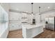 Modern kitchen with white cabinets, stainless steel appliances, and a large island at 420 Westmarch Cir, Loganville, GA 30052