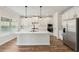 Bright kitchen with quartz countertops, stainless appliances, and white cabinets at 420 Westmarch Cir, Loganville, GA 30052