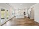 Bright, open kitchen with white cabinets, stainless appliances, and hardwood floors at 420 Westmarch Cir, Loganville, GA 30052
