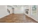 Large living space featuring hardwood floors, a modern fireplace, and stairs to the upper level at 420 Westmarch Cir, Loganville, GA 30052
