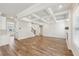Living room showcasing hardwood floors, coffered ceilings, and connected to the kitchen at 420 Westmarch Cir, Loganville, GA 30052