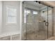 Modern walk-in shower with tiled walls and a built-in bench at 420 Westmarch Cir, Loganville, GA 30052