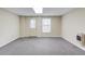 Finished room featuring neutral carpet, a doorway, windows, and baseboard heater at 1924 Sidneys Cv, Lawrenceville, GA 30043