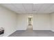 Neutral room has carpeted flooring, a view through a doorway, and a baseboard heater at 1924 Sidneys Cv, Lawrenceville, GA 30043