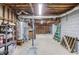 Unfinished basement with exposed utilities, wood beams, a garage door, and concrete floor at 1924 Sidneys Cv, Lawrenceville, GA 30043