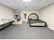 Spacious carpeted basement featuring a bed, shelving, and a glimpse of an additional room at 1924 Sidneys Cv, Lawrenceville, GA 30043