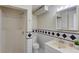 Classic bathroom features a shower, toilet, sink, and decorative black and white tiles at 1924 Sidneys Cv, Lawrenceville, GA 30043