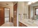 Bathroom with oak cabinets and a long vanity at 1924 Sidneys Cv, Lawrenceville, GA 30043