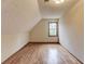 Bright bedroom featuring a window, hardwood floors, and uniquely textured ceiling at 1924 Sidneys Cv, Lawrenceville, GA 30043