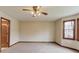 Bright bedroom with a ceiling fan and natural light from a large window at 1924 Sidneys Cv, Lawrenceville, GA 30043