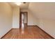 Cozy bedroom showcasing hardwood floors, textured ceilings, and a doorway to another room at 1924 Sidneys Cv, Lawrenceville, GA 30043