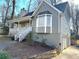 Exterior of a home showing the porch, garage, bay window, and landscaping at 1924 Sidneys Cv, Lawrenceville, GA 30043
