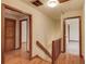 Upstairs hallway with wood floors, paneled doors, and wood railing at 1924 Sidneys Cv, Lawrenceville, GA 30043
