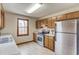 Bright kitchen with stainless steel appliances, wood cabinets, and a large window with natural light at 1924 Sidneys Cv, Lawrenceville, GA 30043