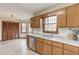 This kitchen features wood cabinets, stainless steel appliances, and an adjacent dining area at 1924 Sidneys Cv, Lawrenceville, GA 30043