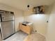 Small kitchenette area with stainless steel refrigerator, countertop and cabinets at 1924 Sidneys Cv, Lawrenceville, GA 30043