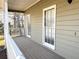 Charming porch with natural light and gray stained wood flooring at 1924 Sidneys Cv, Lawrenceville, GA 30043