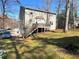 Backyard view of a home featuring a spacious deck and well-maintained lawn at 1924 Sidneys Cv, Lawrenceville, GA 30043