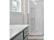 Bathroom with a gray cabinet vanity, white countertops, a window, and glass-enclosed shower at 317 Skye Ln # 51, Cartersville, GA 30121
