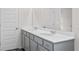 A bathroom features a double vanity with gray cabinets, white countertops, and a large mirror at 317 Skye Ln # 51, Cartersville, GA 30121