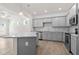 Stylish kitchen with gray cabinetry, granite counters, a center island, and modern stainless steel appliances at 317 Skye Ln # 51, Cartersville, GA 30121