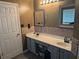 Double sink bathroom with a modern vanity and a stylish backsplash, combining functionality with contemporary design elements at 8827 Lake Rd, Union City, GA 30291
