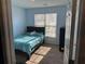 This charming bedroom features a twin bed, a black dresser, and a window with natural sunlight at 8827 Lake Rd, Union City, GA 30291
