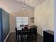Dining room with tall ceilings, pendant lights, and a dark wood dining table and chairs at 8827 Lake Rd, Union City, GA 30291
