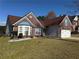Charming single-Gathering home with brick exterior, bay window, 2-car garage and well-manicured lawn at 8827 Lake Rd, Union City, GA 30291