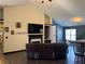 Spacious living room with vaulted ceiling, fireplace, flatscreen tv, hardwood floors, and modern decor at 8827 Lake Rd, Union City, GA 30291