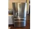 Stainless steel, four door refrigerator with water dispenser in a well-lit kitchen at 8827 Lake Rd, Union City, GA 30291