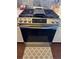 Stainless steel stove with a glass top and a digital display in a kitchen with decorative backsplash at 8827 Lake Rd, Union City, GA 30291
