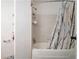 Bathtub with decorative shower curtain and tiled surround at 417 Ridge Creek Dr, Clarkston, GA 30021