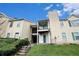 Multi-level condo building with balconies, lush landscaping, and a well-maintained lawn at 417 Ridge Creek Dr, Clarkston, GA 30021
