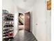 Hallway with laminate flooring, shoe racks, and entrance to a stairwell at 417 Ridge Creek Dr, Clarkston, GA 30021