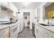 Updated kitchen featuring white appliances, counters, and laminate flooring at 417 Ridge Creek Dr, Clarkston, GA 30021