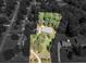 Expansive aerial view of a home surrounded by lush greenery on a large lot with a winding driveway at 5 Ridgewood Cir, Mcdonough, GA 30252