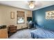 Comfortable bedroom featuring a window, an end table, a ceiling fan, and a quirky accent wall at 5 Ridgewood Cir, Mcdonough, GA 30252