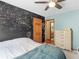 Inviting bedroom with a black accent wall covered with writing and an adjoining door to a bathroom at 5 Ridgewood Cir, Mcdonough, GA 30252