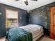 Comfortable bedroom featuring a black wall with writing and artwork, a window, and a wooden door at 5 Ridgewood Cir, Mcdonough, GA 30252